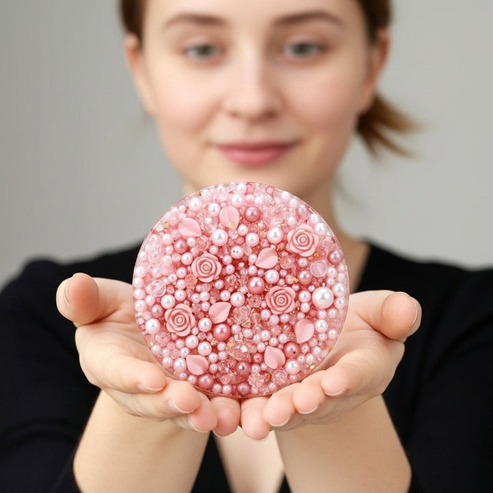 Smiling woman holding the 10cm pink rose picky pad, demonstrating its size and visual appeal.